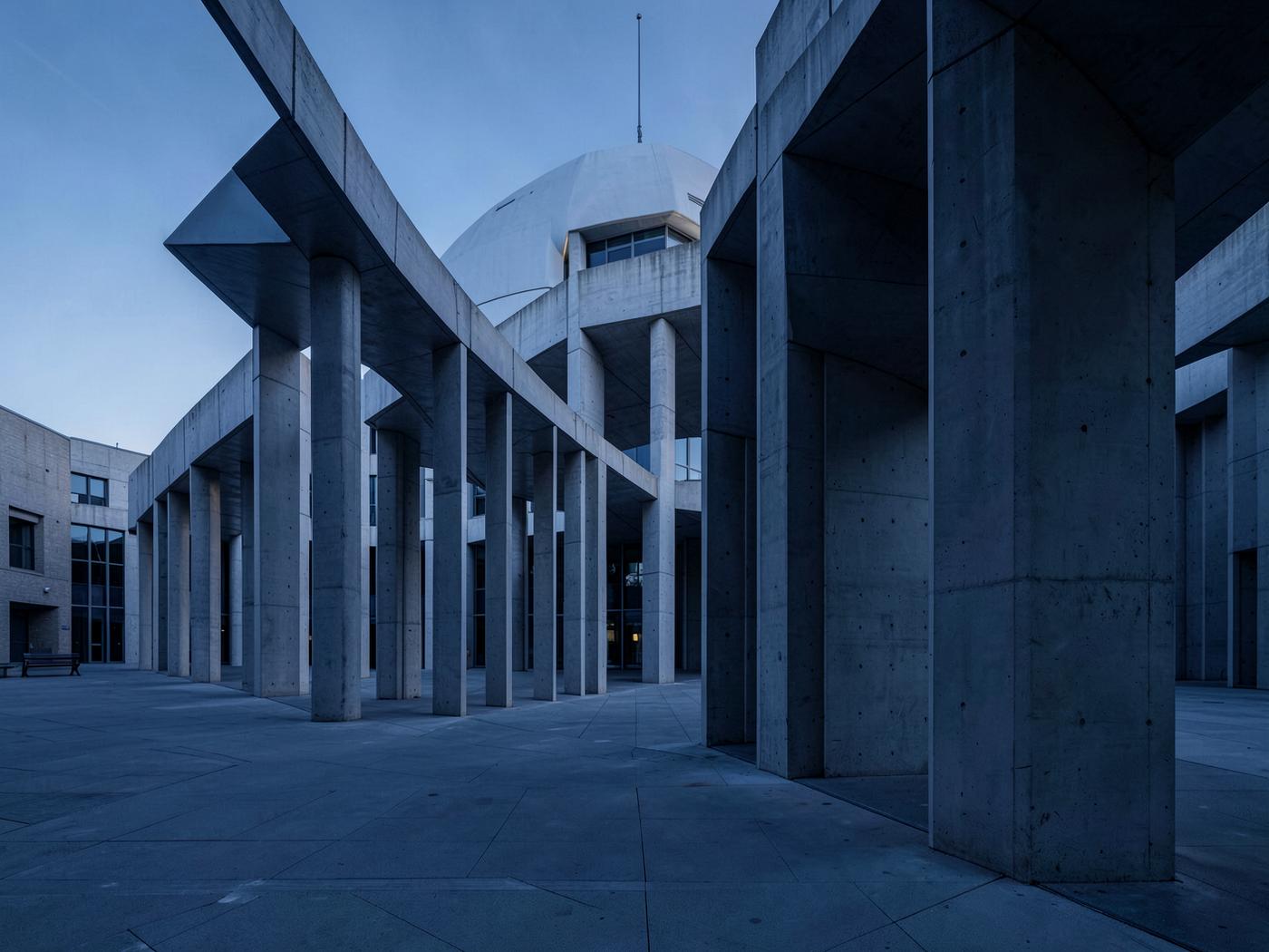 Concrete colonnade of a civic building in cool morning light